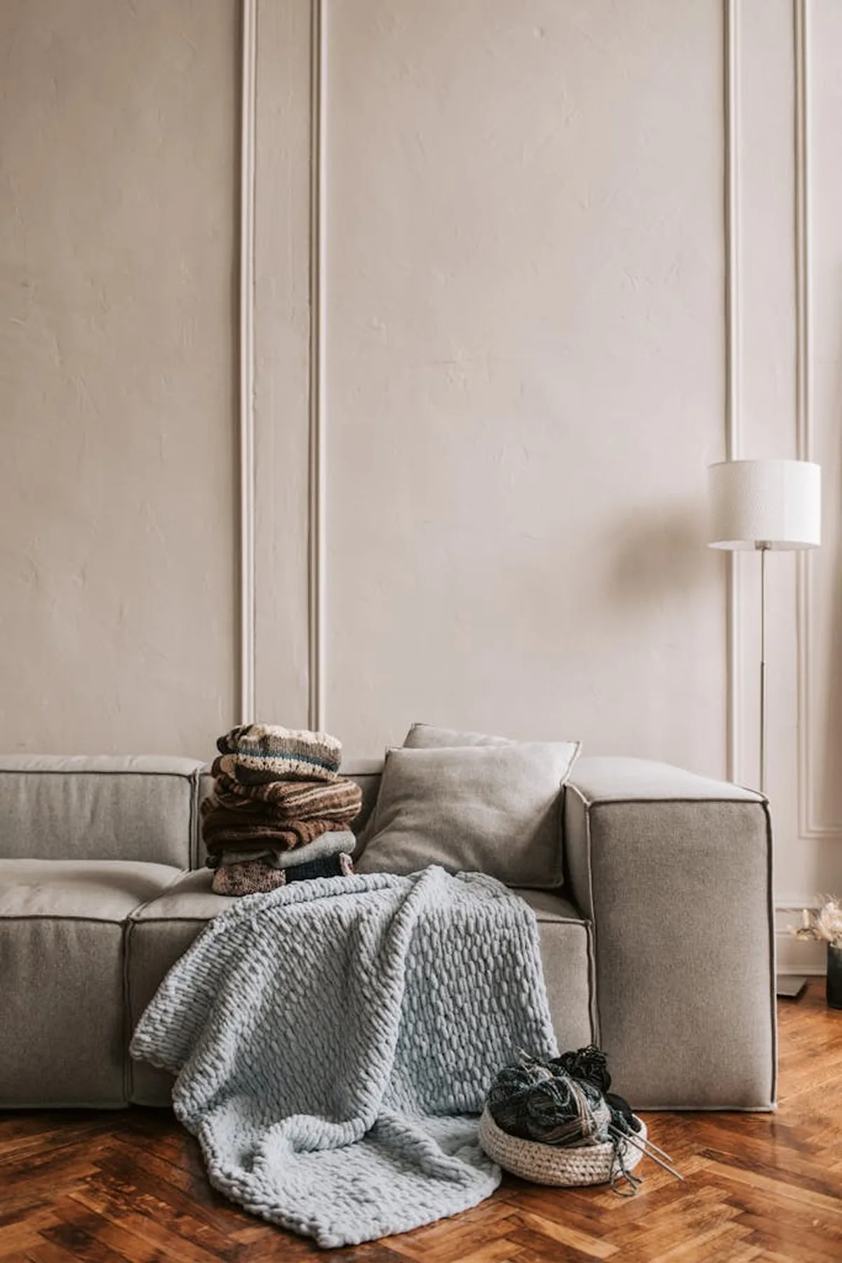 Restored living room with a sofa, textiles and wood flooring