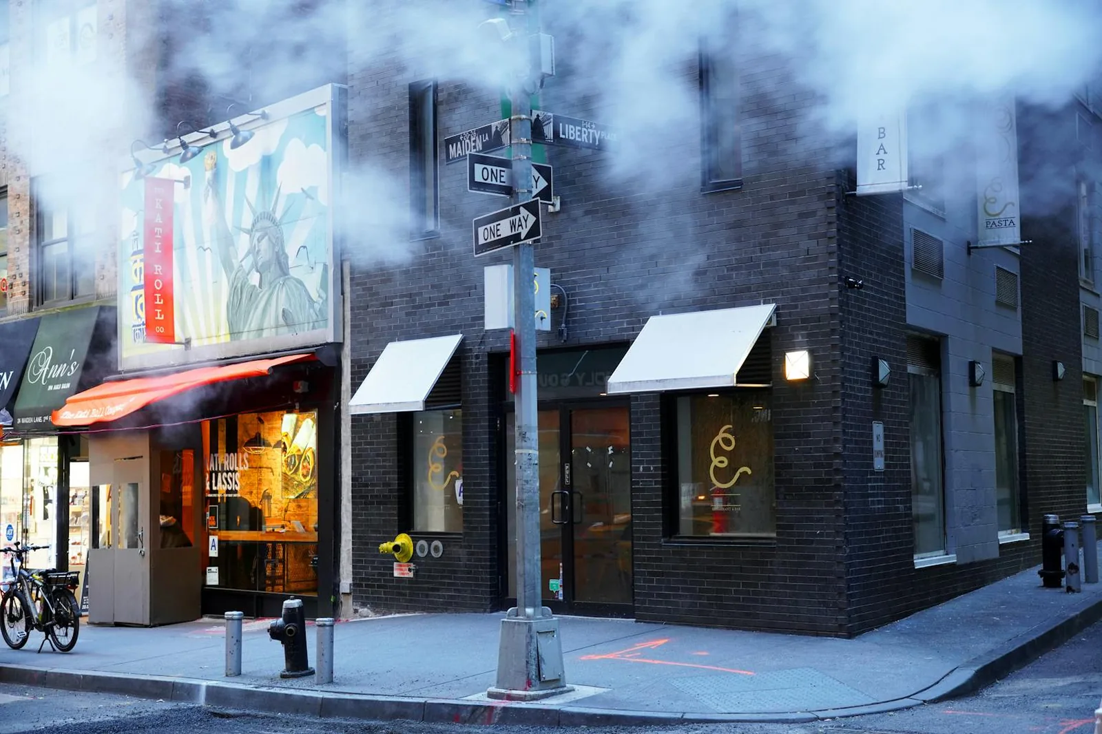 Heavy smoke drifting across a city street corner
